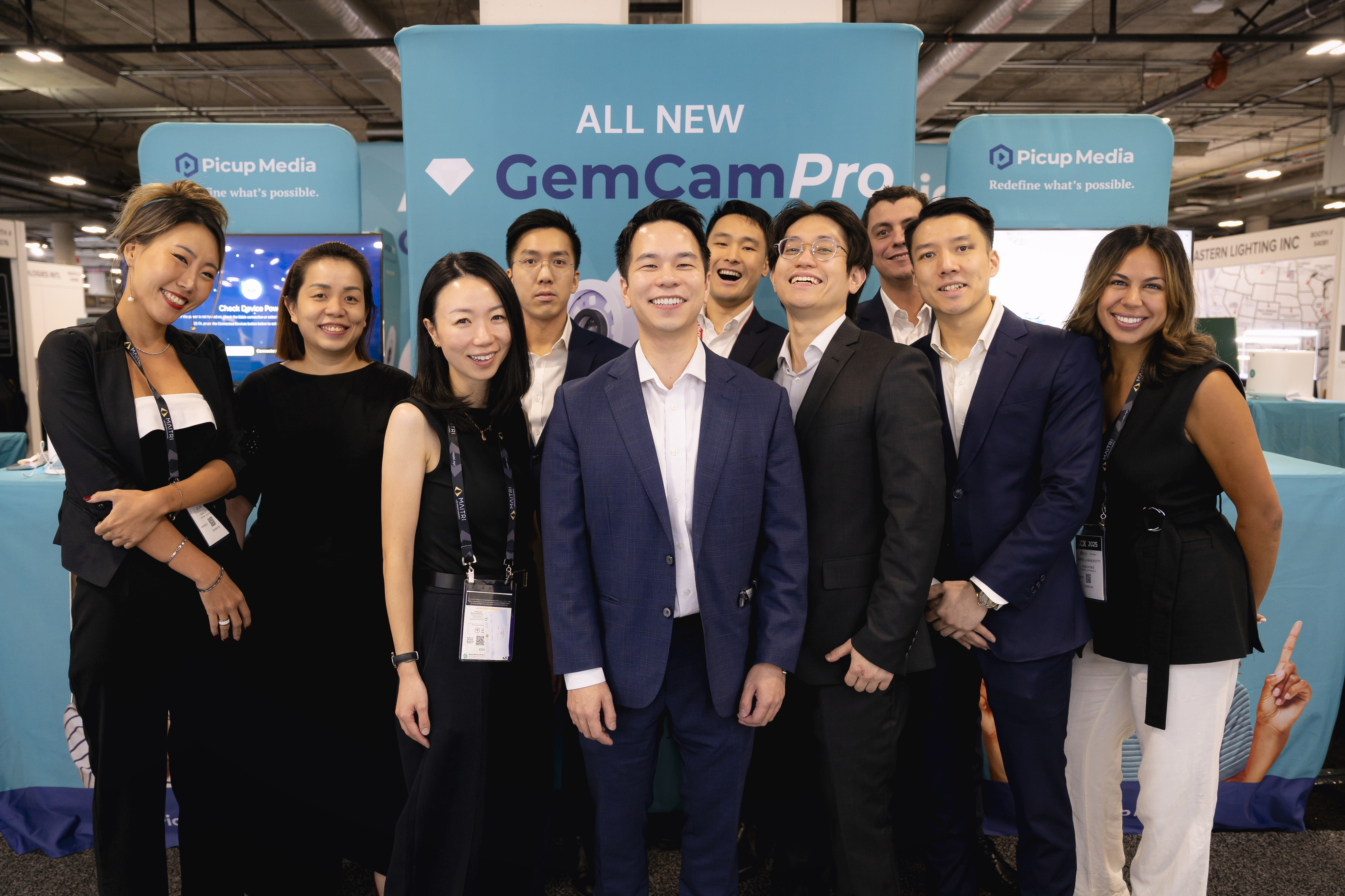 GemIQ team in professional dress at trade show booth